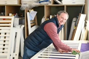 Stripey Stork volunteer working on cots for safe sleep WEB